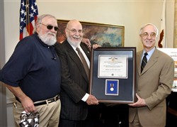 Deputy Secretary of Defense Gordon England (right) presents the Department of Defense Medal for Distinguished Public Service to Robert Rosenthal. photo by R. D. Ward 